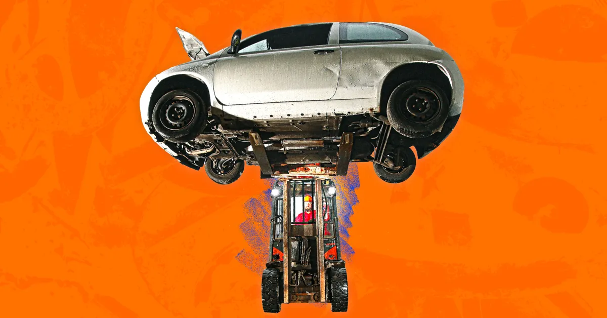 A silver car with exposed wheels and engine on an orange background.