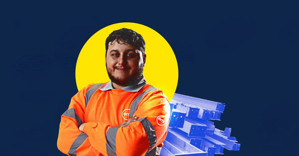 A person in an orange safety jacket posing with their arms crossed.