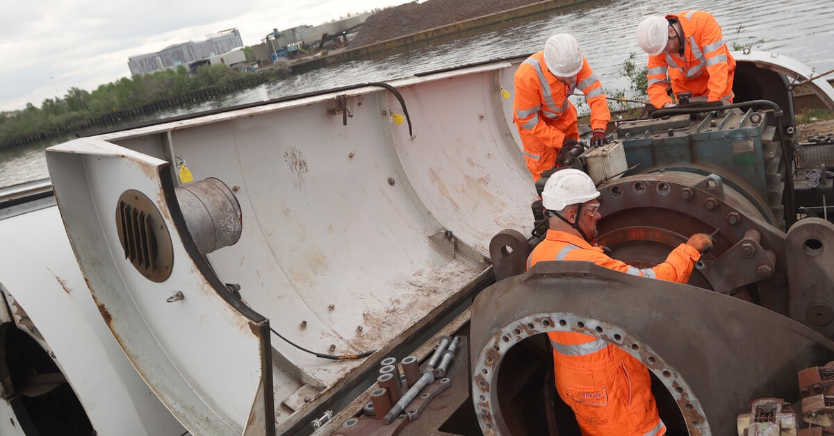 People dismantling a wind turbine