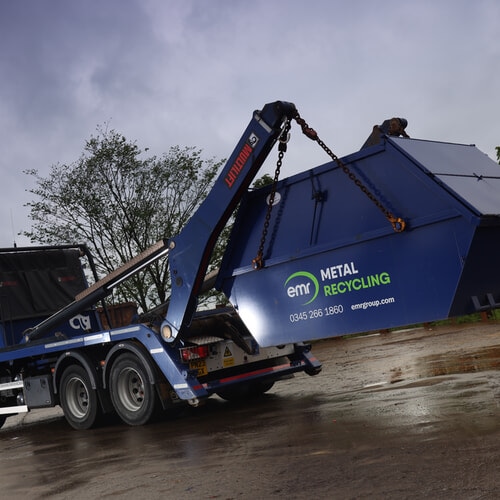 Recycling skip loaded onto back of an EMR truck