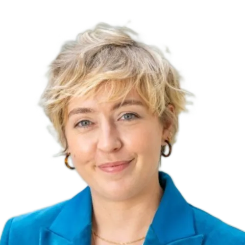 Person with blond hair smiling at the camera, with a yellow background