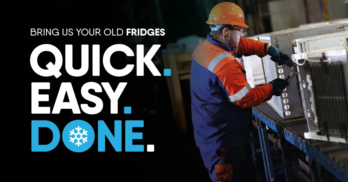 Person wearing safety clothing and recycling a fridge.