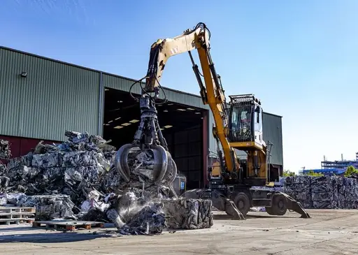 Machine grabber holding recycled materials