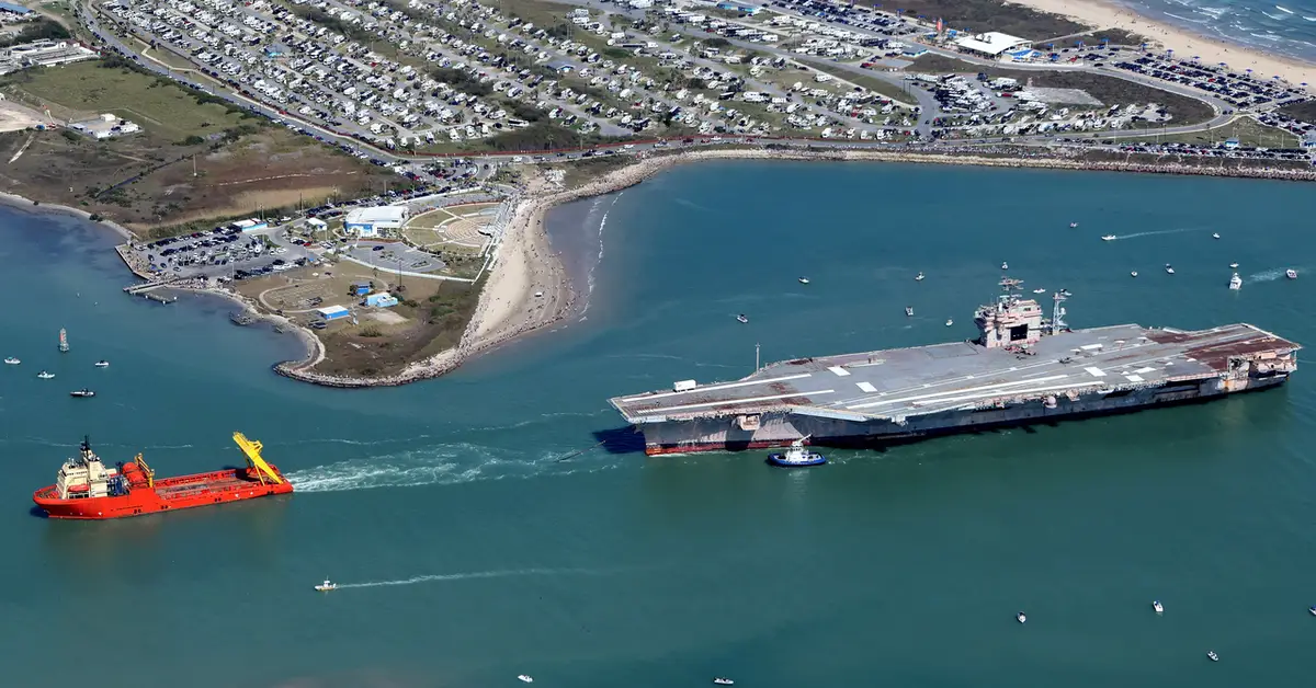 John F Kennedy aircraft carrier being towed