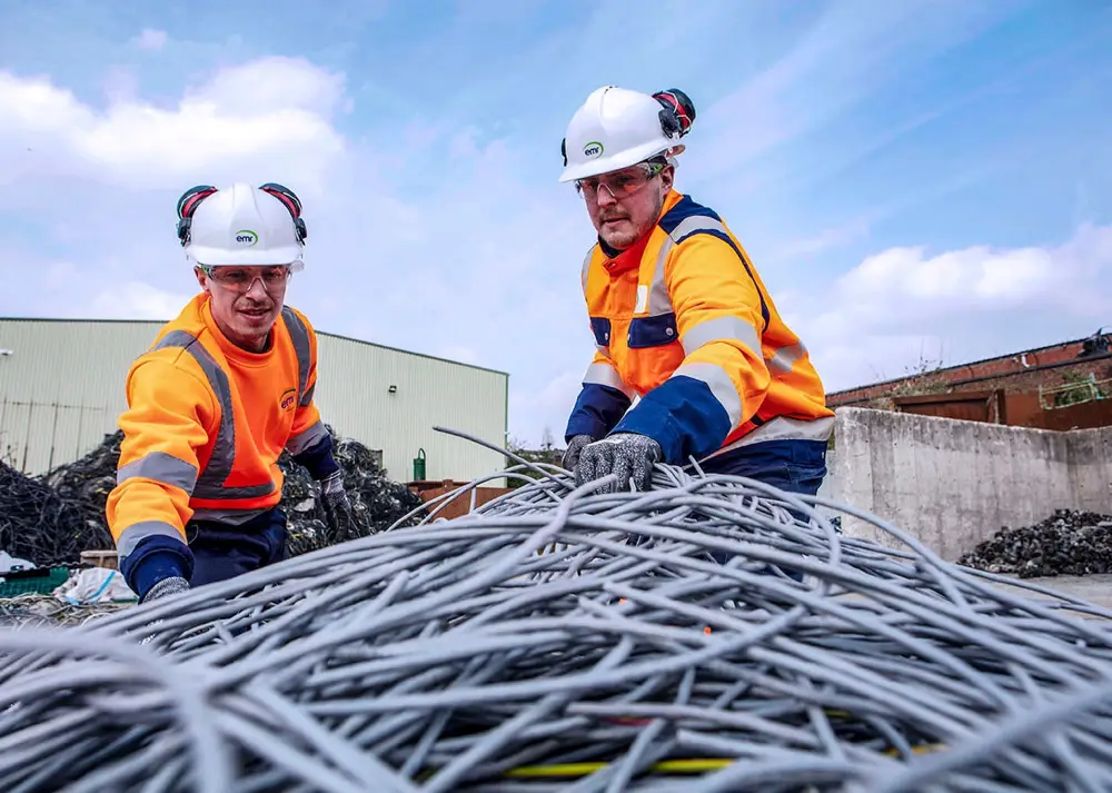 People stripping cable for recycling