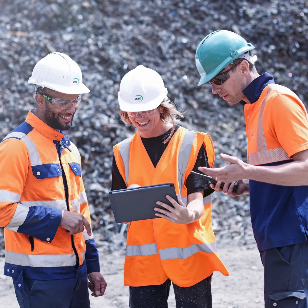 Three people looking at data on an iPad.