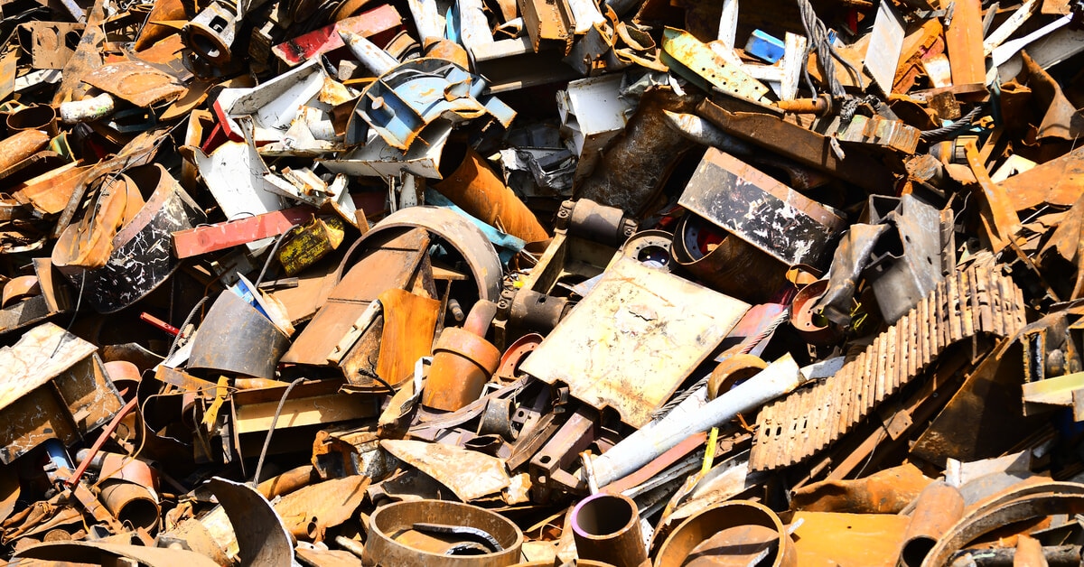 Ein großer Haufen an Abfallmaterialien aller Art, darunter verrostete Metallteile, alte Maschinenteile und verschiedene weggeworfene Gegenstände.