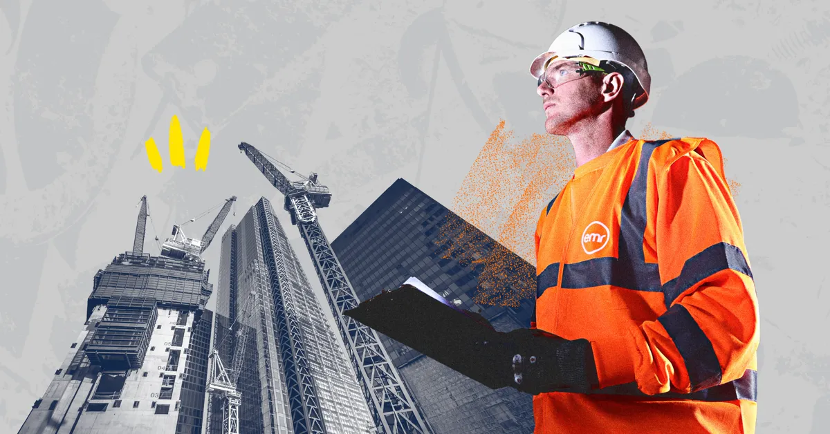 A person wearing a hard hat and holding a clipboard.
