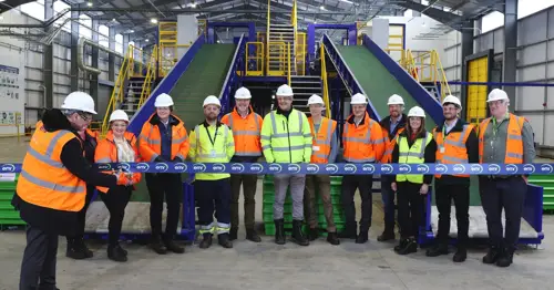 People stood in a line whilst someone cuts the ribbon