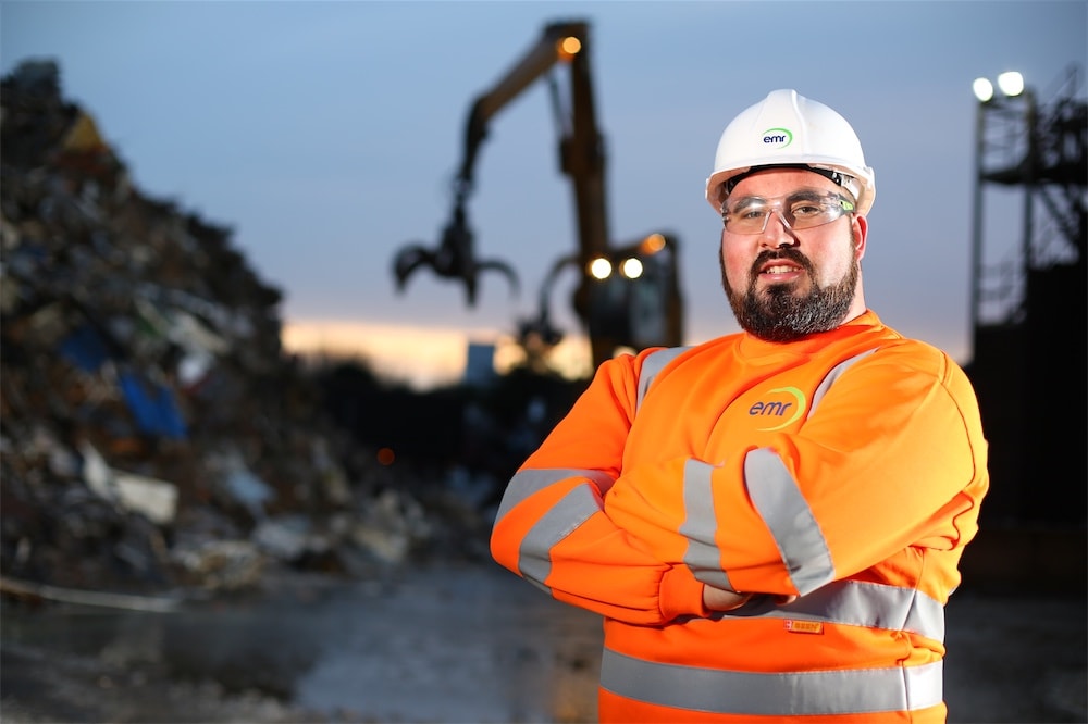 Worker stood in recycling centre