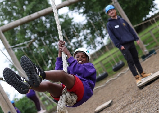 Child swinging on rope.