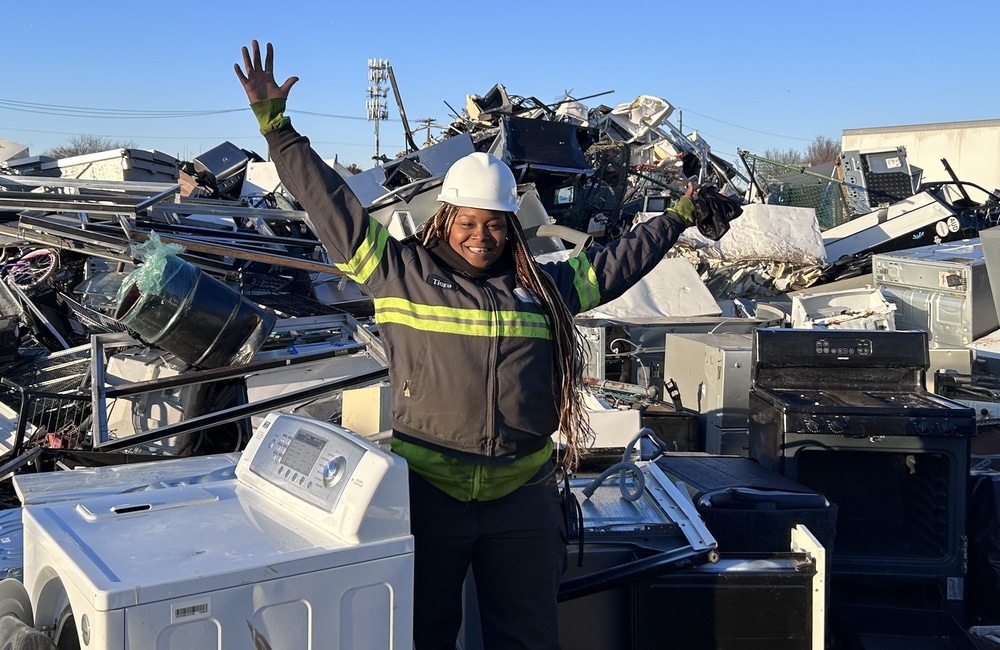 tiera standing in middle of waste metal pile
