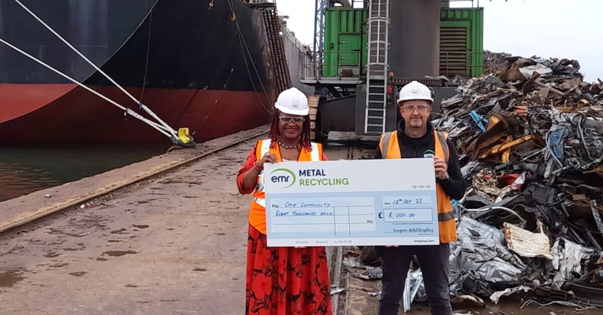 One Community receiving donation, stood in front of ship at Tilbury Dock
