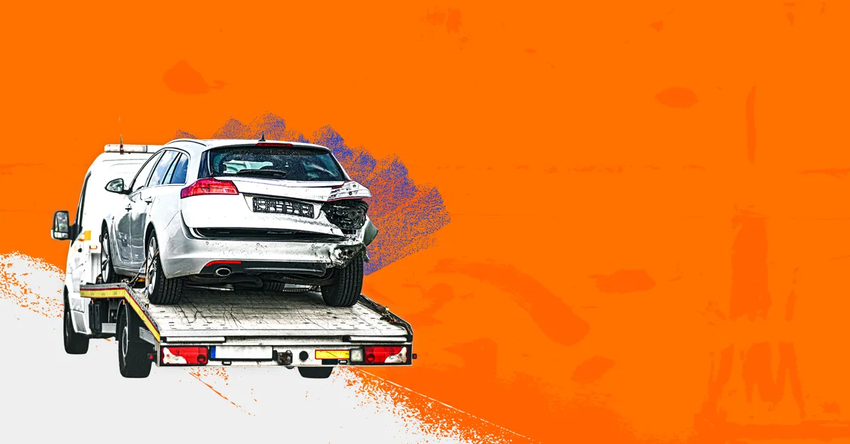 A white car on a trailer with an orange background.